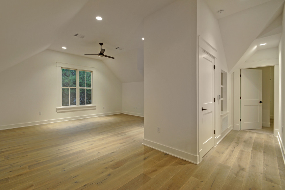 Mid-sized farmhouse loft-style laminate floor and beige floor family room photo in Austin with white walls