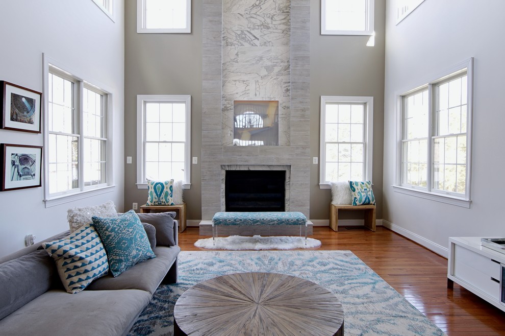 Example of a beach style family room design in DC Metro with gray walls, a standard fireplace and a tile fireplace
