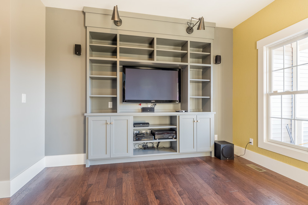 This is an example of a medium sized industrial enclosed games room in Chicago with a game room, yellow walls, medium hardwood flooring, no fireplace and a built-in media unit.