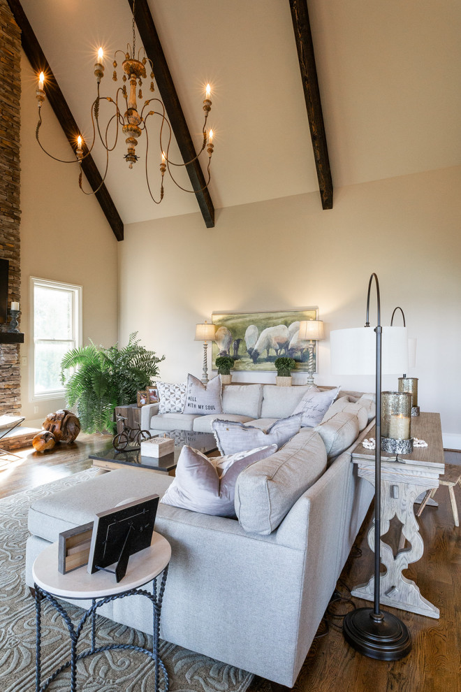 Example of a huge cottage open concept medium tone wood floor family room design in Birmingham with a standard fireplace and a stone fireplace