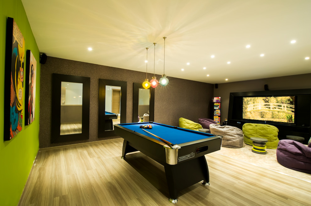Inspiration for a large contemporary enclosed games room in Other with green walls, medium hardwood flooring, no fireplace and a wall mounted tv.