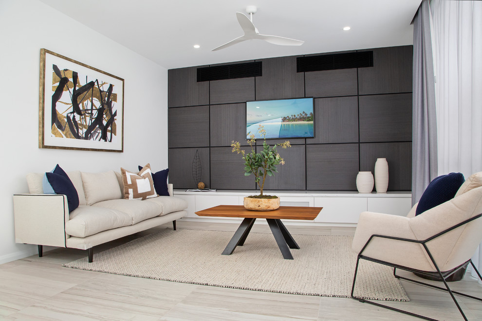 This is an example of a small contemporary open plan games room in Gold Coast - Tweed with porcelain flooring, a wall mounted tv, white walls, grey floors and a feature wall.