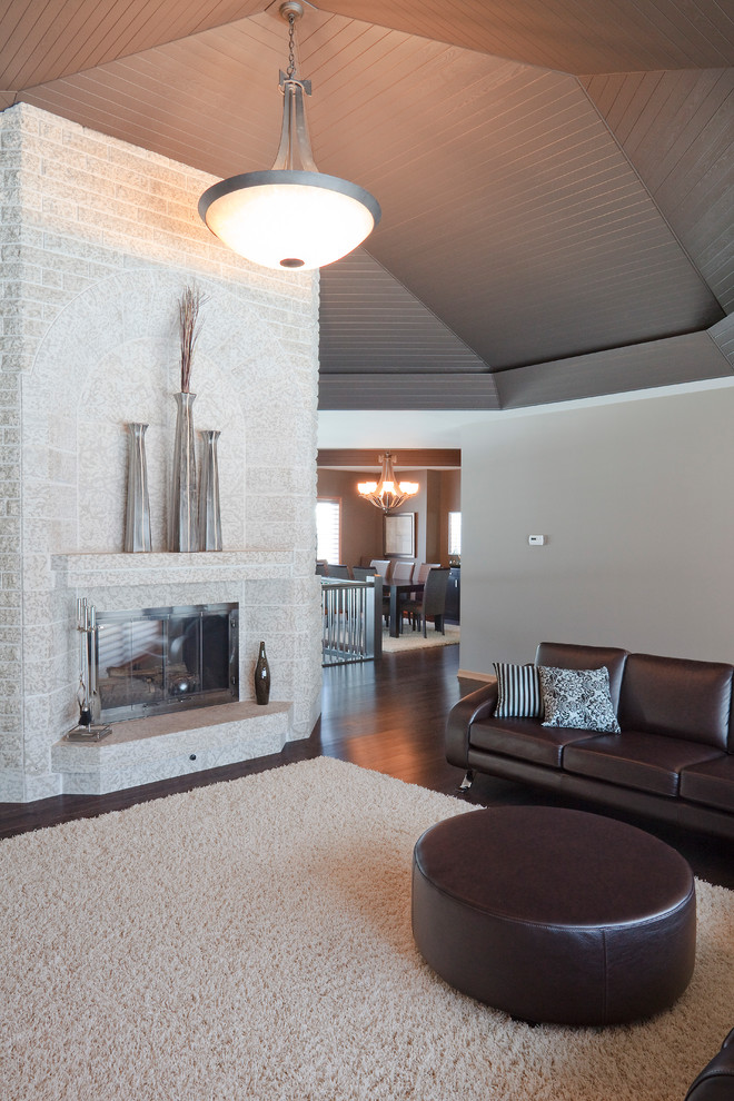 Inspiration for a large contemporary open concept dark wood floor and brown floor game room remodel in Other with a standard fireplace and a brick fireplace