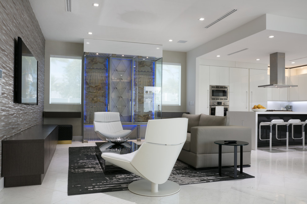 Medium sized contemporary open plan games room in Miami with a home bar, grey walls, marble flooring, a wall mounted tv and white floors.