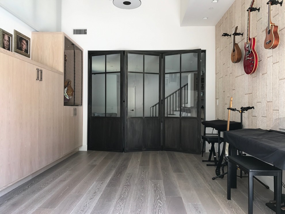 Design ideas for a large modern open plan games room in San Diego with a music area, white walls, light hardwood flooring, no tv and no fireplace.
