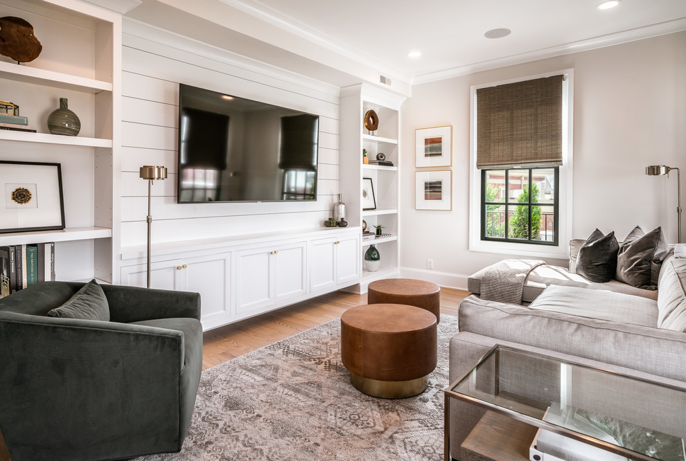 Inspiration for a transitional light wood floor family room library remodel in Louisville with gray walls, no fireplace and a media wall