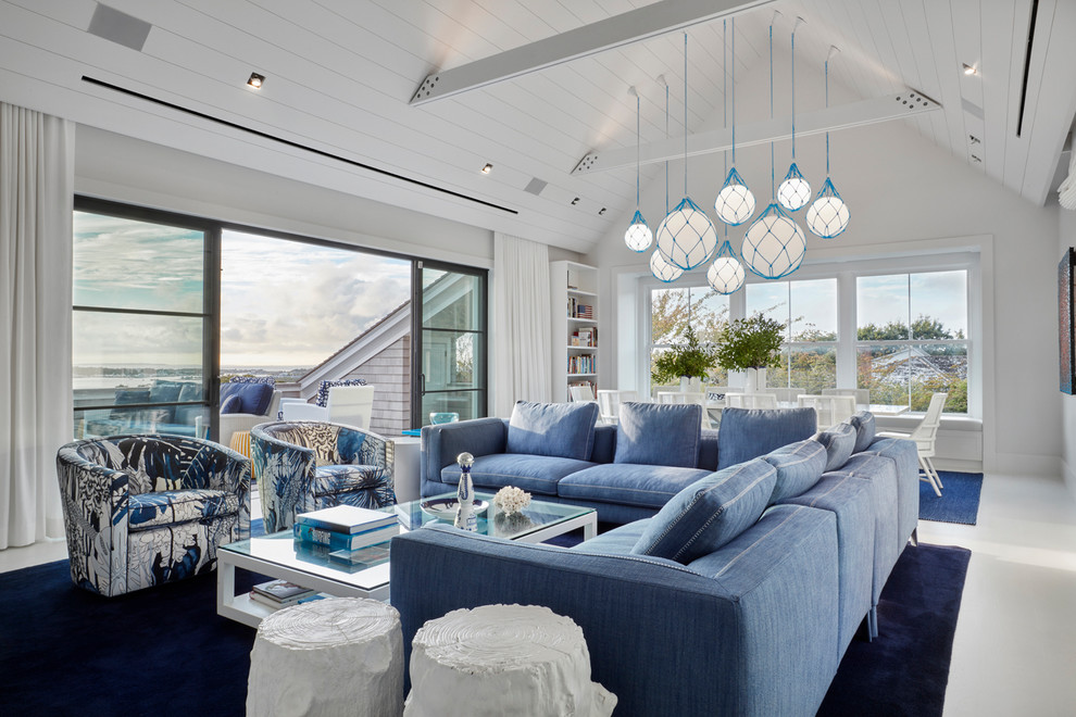 This is an example of a coastal open plan games room in New York with white walls, carpet and blue floors.