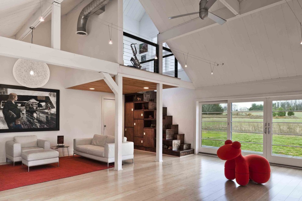 Inspiration for a country light wood floor family room remodel in Philadelphia with white walls