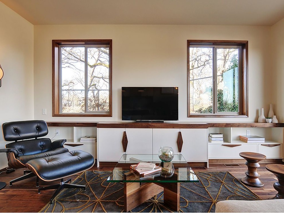 Family room - 1960s dark wood floor family room idea in Vancouver with beige walls and a tv stand