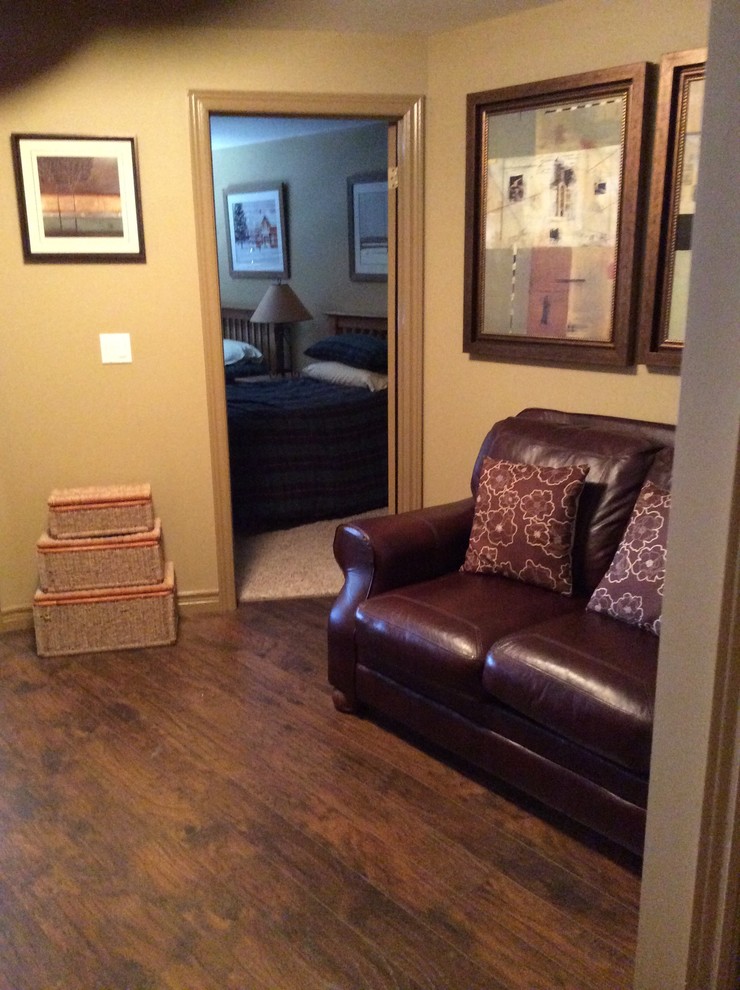 Imagen de sala de estar cerrada rural pequeña sin chimenea con paredes beige, suelo de madera oscura y televisor independiente