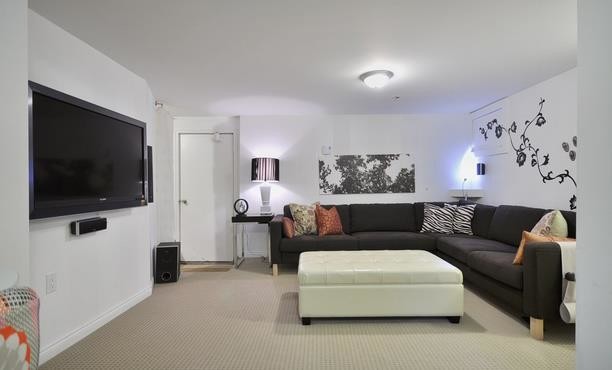 На фото: изолированная комната для игр среднего размера в современном стиле с белыми стенами, телевизором на стене и ковровым покрытием без камина