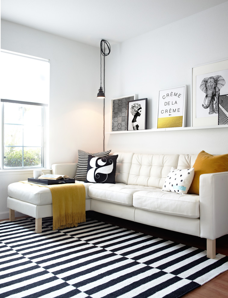 Family room - scandinavian carpeted family room idea in San Francisco with white walls