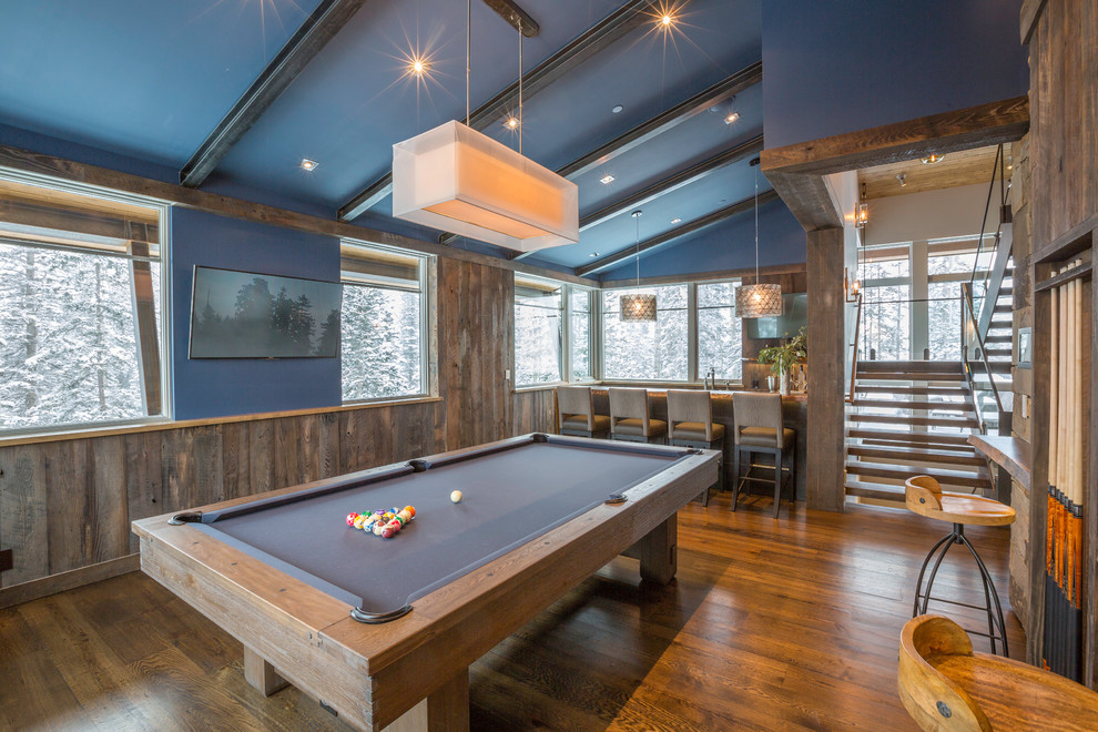 Game room - large transitional open concept medium tone wood floor game room idea in Denver with brown walls and a wall-mounted tv
