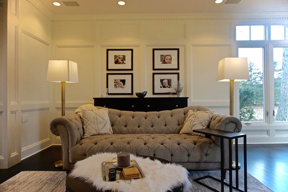 Diseño de sala de estar clásica renovada grande con paredes blancas, suelo de madera oscura, todas las chimeneas, marco de chimenea de madera y televisor colgado en la pared