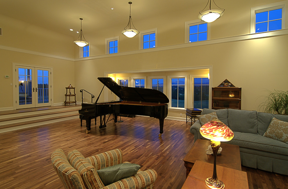 Photo of a medium sized traditional enclosed games room in Seattle with yellow walls, medium hardwood flooring, a standard fireplace, a stone fireplace surround, no tv and beige floors.
