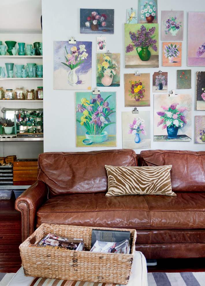 Family room - eclectic dark wood floor family room idea in New York with white walls and no tv
