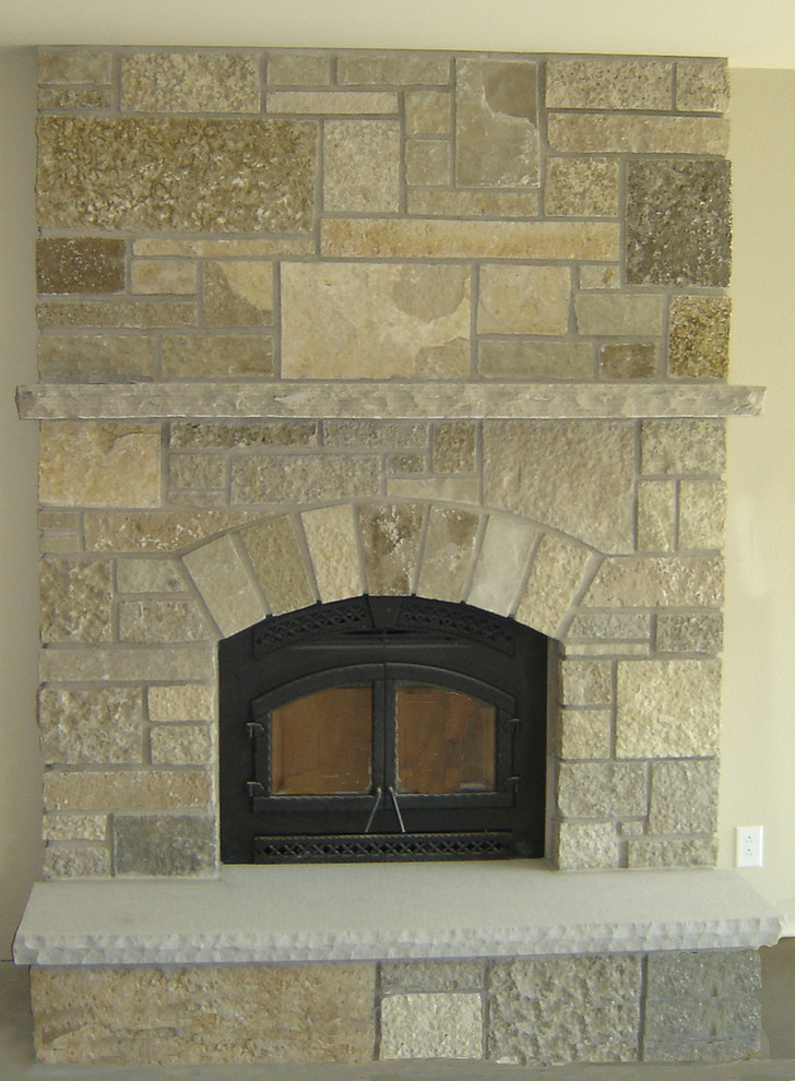Example of a family room design in Minneapolis with a standard fireplace and a stone fireplace