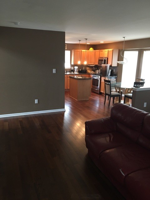 Elegant medium tone wood floor and red floor family room photo in Philadelphia