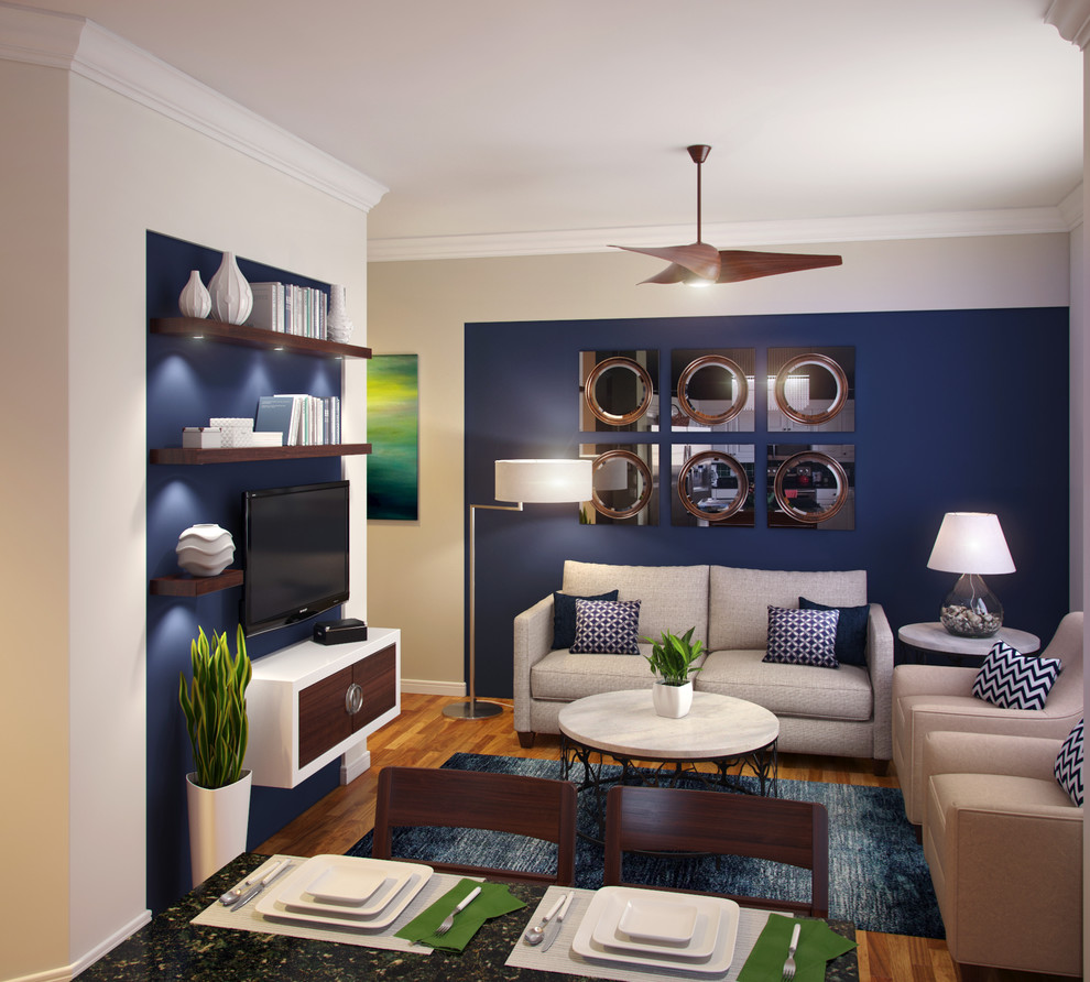 На фото: изолированная гостиная комната в стиле модернизм с светлым паркетным полом, телевизором на стене, разноцветными стенами и ковром на полу без камина с