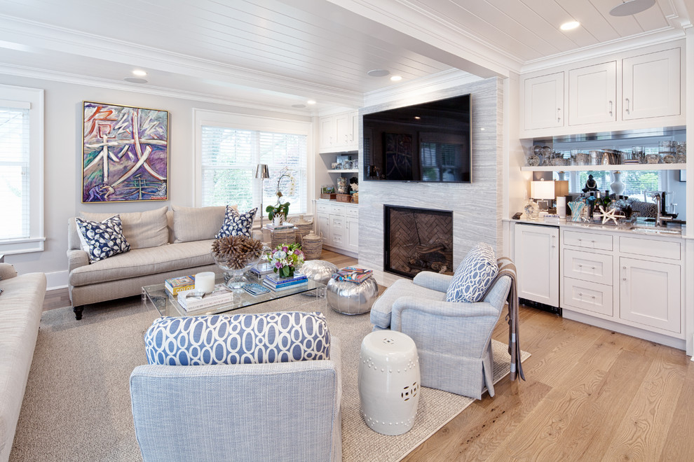 Transitional open concept light wood floor family room photo in New York with a bar, white walls, a standard fireplace, a stone fireplace and a tv stand