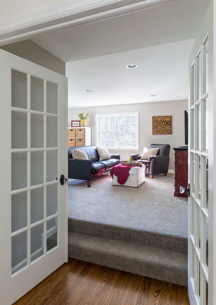 Mid-sized transitional enclosed carpeted family room photo in Minneapolis with white walls, no fireplace and a tv stand