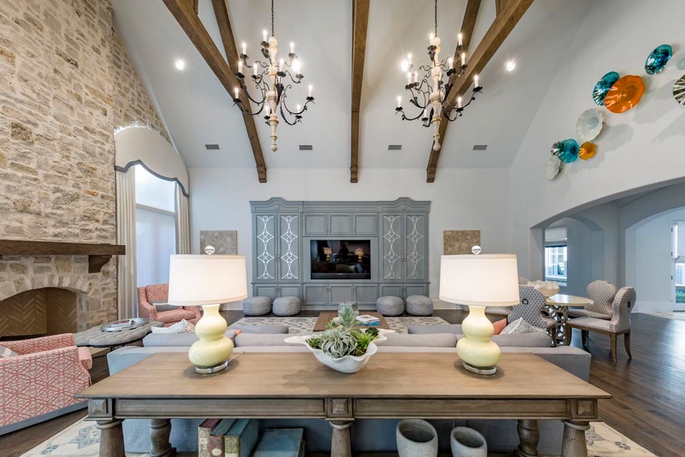Example of a huge transitional open concept dark wood floor and brown floor family room design in Dallas with gray walls, a standard fireplace, a stone fireplace and a wall-mounted tv