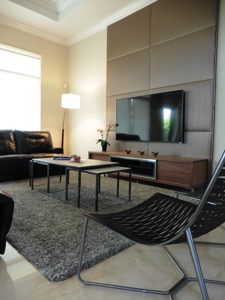 Example of a mid-sized minimalist open concept porcelain tile and beige floor family room design in Miami with a wall-mounted tv and beige walls