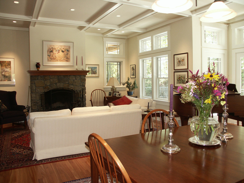 Example of a large classic open concept medium tone wood floor family room design in Boston with a music area, white walls, a standard fireplace, a stone fireplace and no tv