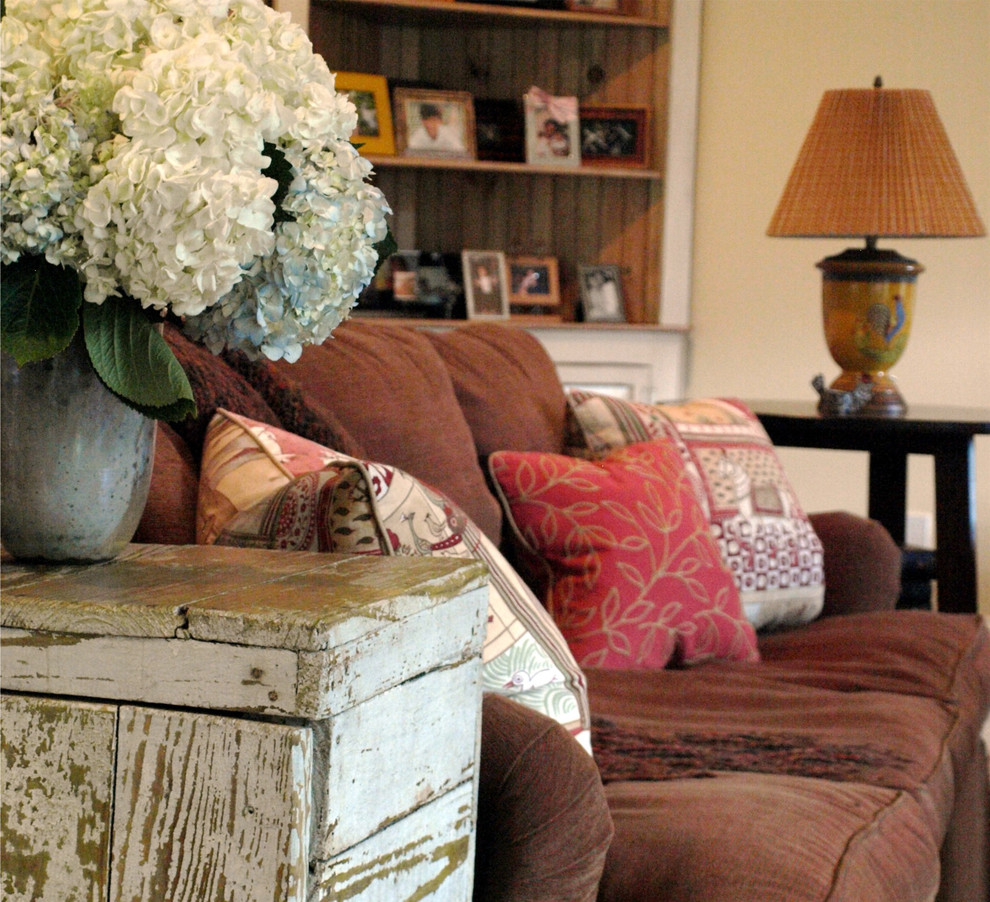 Immagine di un ampio soggiorno tradizionale aperto con pareti beige, parquet scuro, camino classico, cornice del camino in pietra e TV nascosta