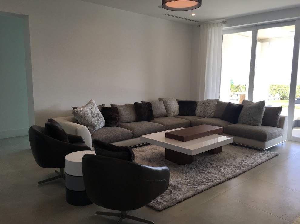 Large trendy open concept concrete floor family room photo in Miami with white walls, no fireplace and no tv