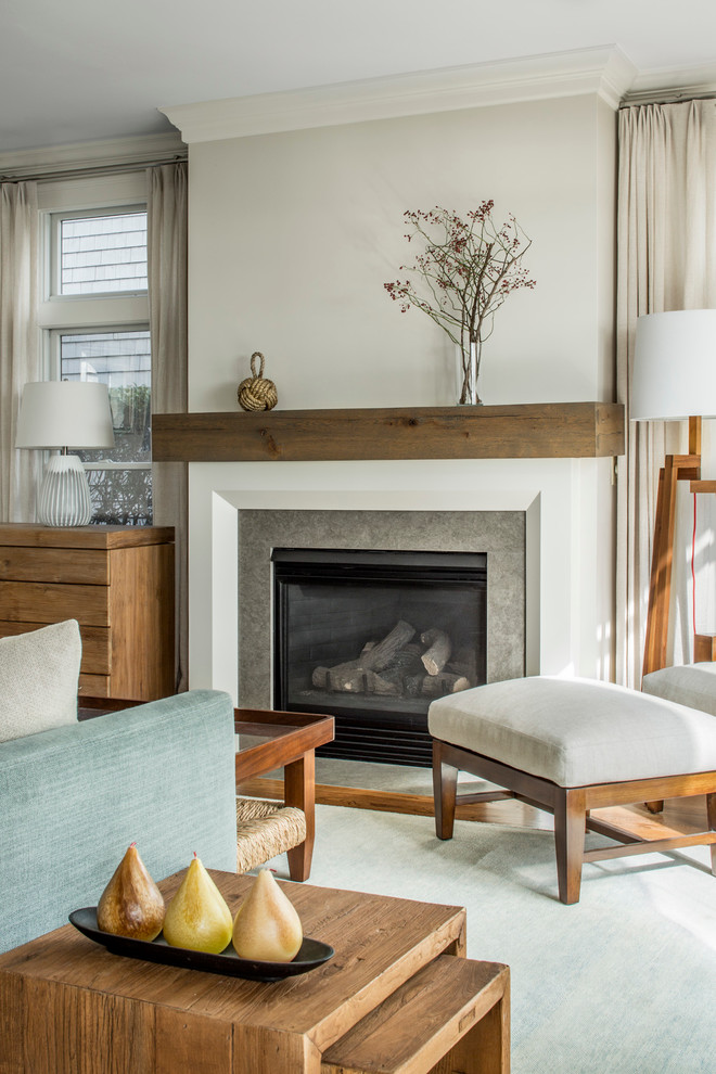 Example of a small beach style enclosed light wood floor family room library design in Boston with beige walls, no fireplace, a concealed tv and a stone fireplace