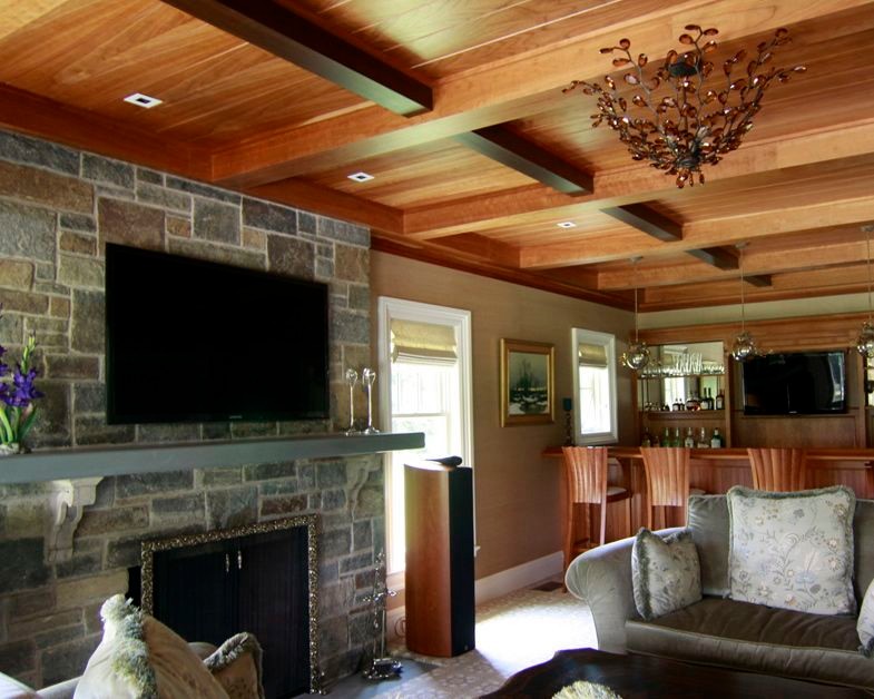 Example of a mid-sized classic open concept carpeted family room design in New York with a bar, beige walls, a stone fireplace and a wall-mounted tv