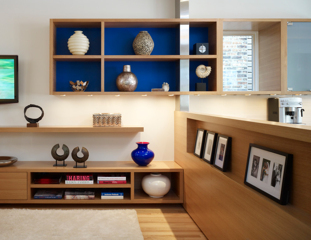 Family room - modern light wood floor family room idea in Chicago with beige walls