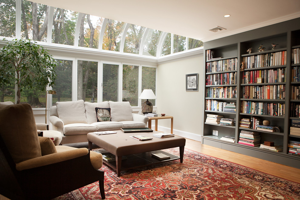 Example of a mid-sized eclectic enclosed light wood floor family room design in New York with gray walls