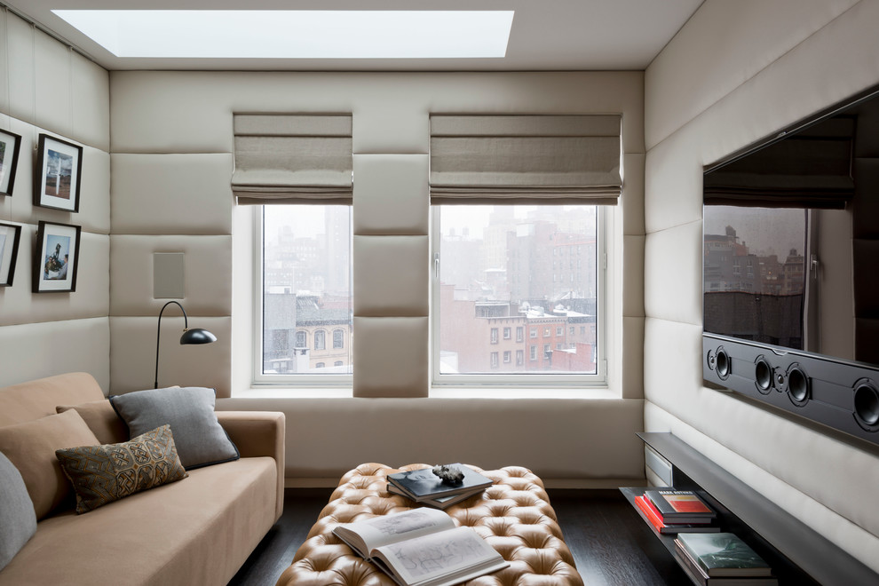 Пример оригинального дизайна: изолированная гостиная комната в современном стиле с бежевыми стенами, темным паркетным полом и телевизором на стене без камина