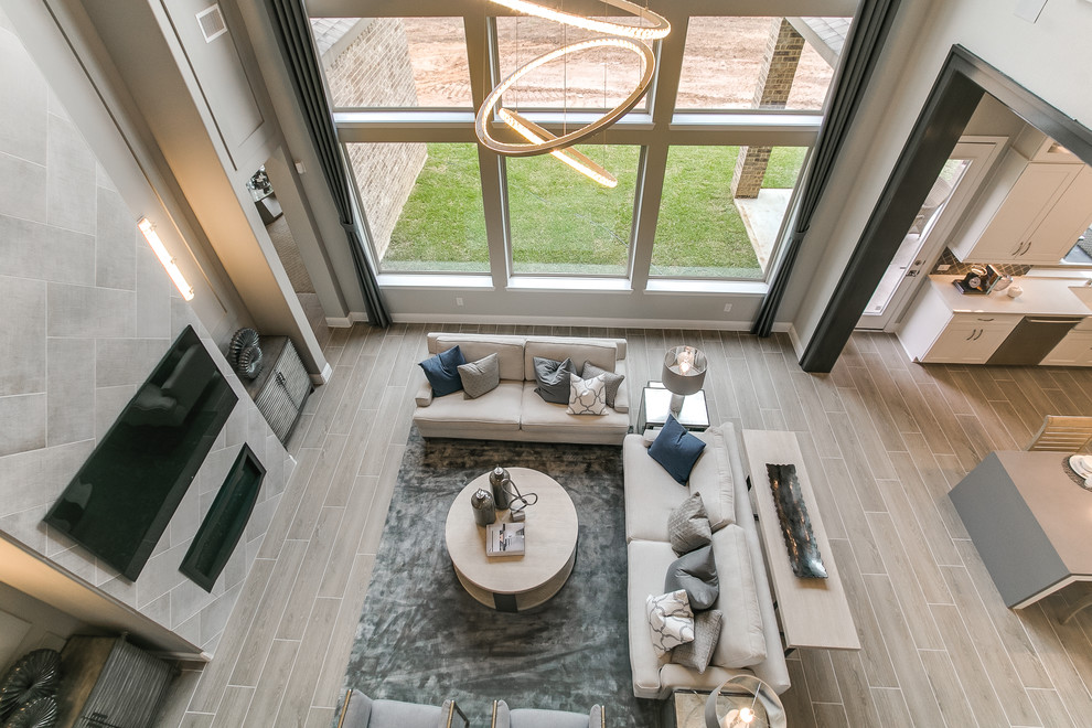 Пример оригинального дизайна: гостиная комната в стиле модернизм с серыми стенами, серым полом, полом из керамической плитки, горизонтальным камином и фасадом камина из плитки