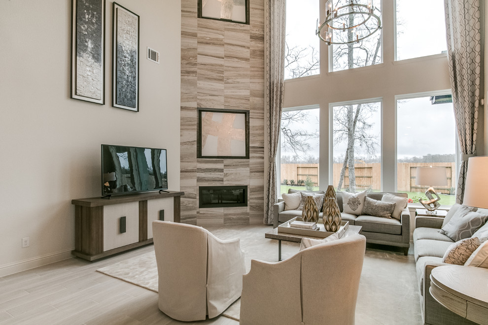 Example of a minimalist ceramic tile and beige floor family room design in Houston with beige walls, a corner fireplace and a tile fireplace
