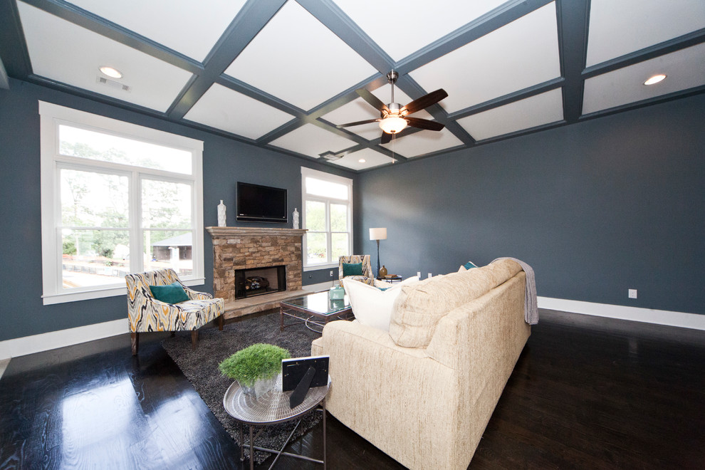 Inspiration for a huge transitional open concept dark wood floor family room remodel in Atlanta with gray walls, a standard fireplace, a stone fireplace and a wall-mounted tv