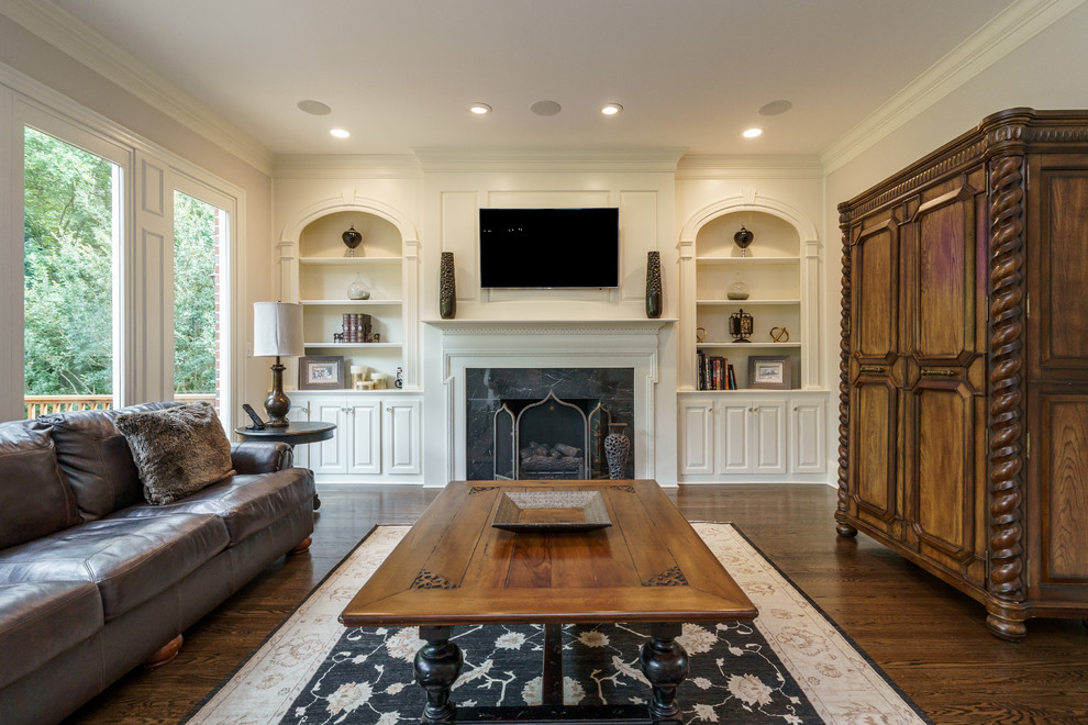 Family room - large traditional open concept medium tone wood floor and brown floor family room idea in Raleigh with gray walls, a standard fireplace, a stone fireplace and a wall-mounted tv