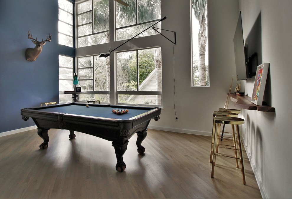 Photo of a large contemporary enclosed games room in Orange County with a game room, white walls, a wall mounted tv and light hardwood flooring.