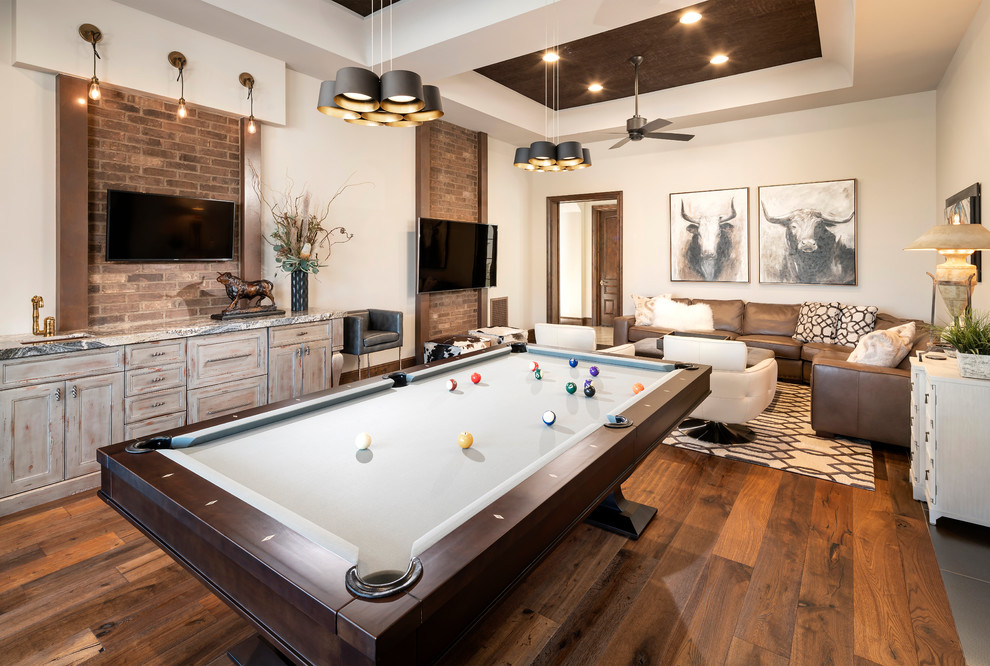 Inspiration for an enclosed games room in Phoenix with beige walls, medium hardwood flooring, a wall mounted tv and no fireplace.