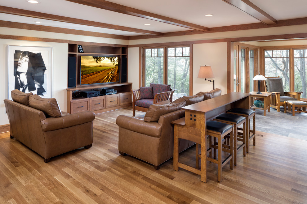 Large arts and crafts open concept medium tone wood floor and brown floor family room photo in Minneapolis with beige walls, a standard fireplace, a brick fireplace and a concealed tv