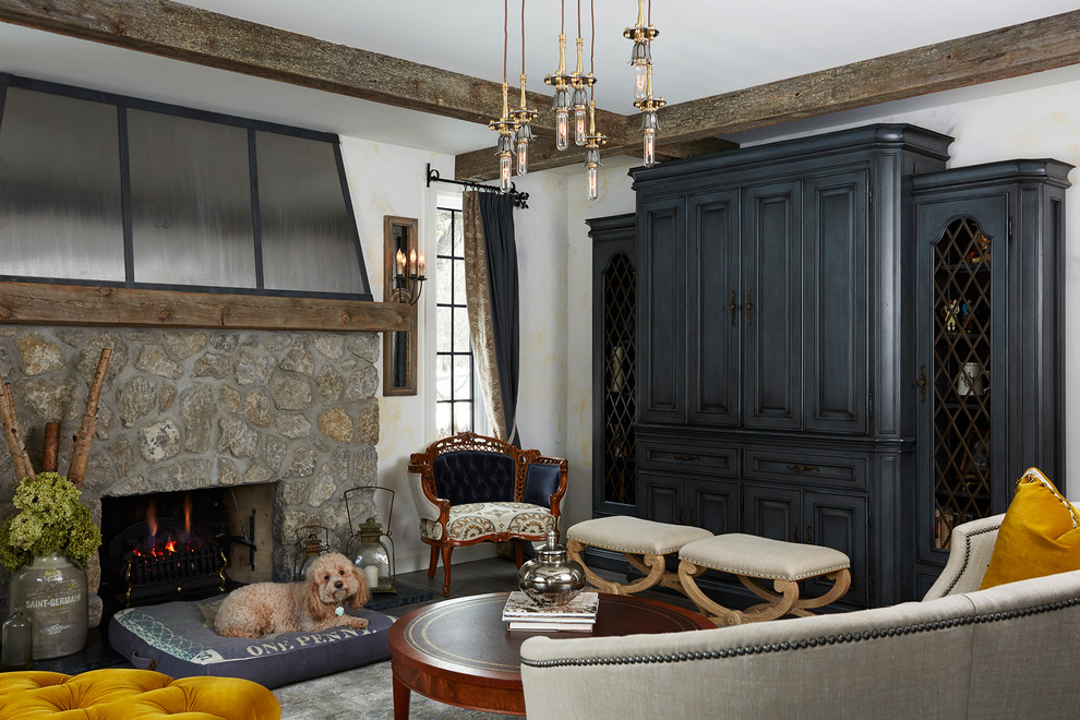 Example of a mid-sized classic open concept family room design in Minneapolis with white walls, a standard fireplace, a stone fireplace and a concealed tv