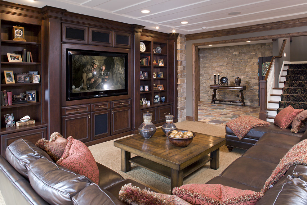 This is an example of a large classic open plan games room in Minneapolis with brown walls, carpet, a standard fireplace, a built-in media unit, a game room and a stone fireplace surround.