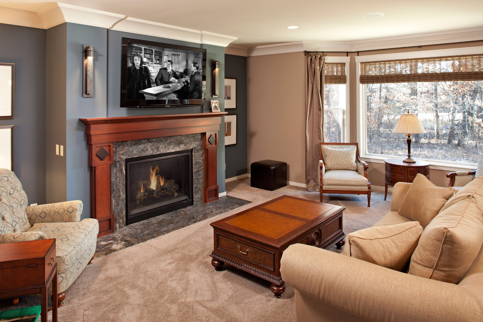 This is an example of a large traditional open plan games room in Minneapolis with multi-coloured walls, carpet, a standard fireplace, a wall mounted tv and a stone fireplace surround.