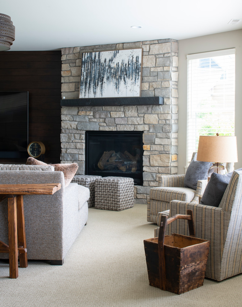 Large open concept carpeted and gray floor family room photo in Minneapolis with a bar, gray walls, a standard fireplace, a stone fireplace and a wall-mounted tv