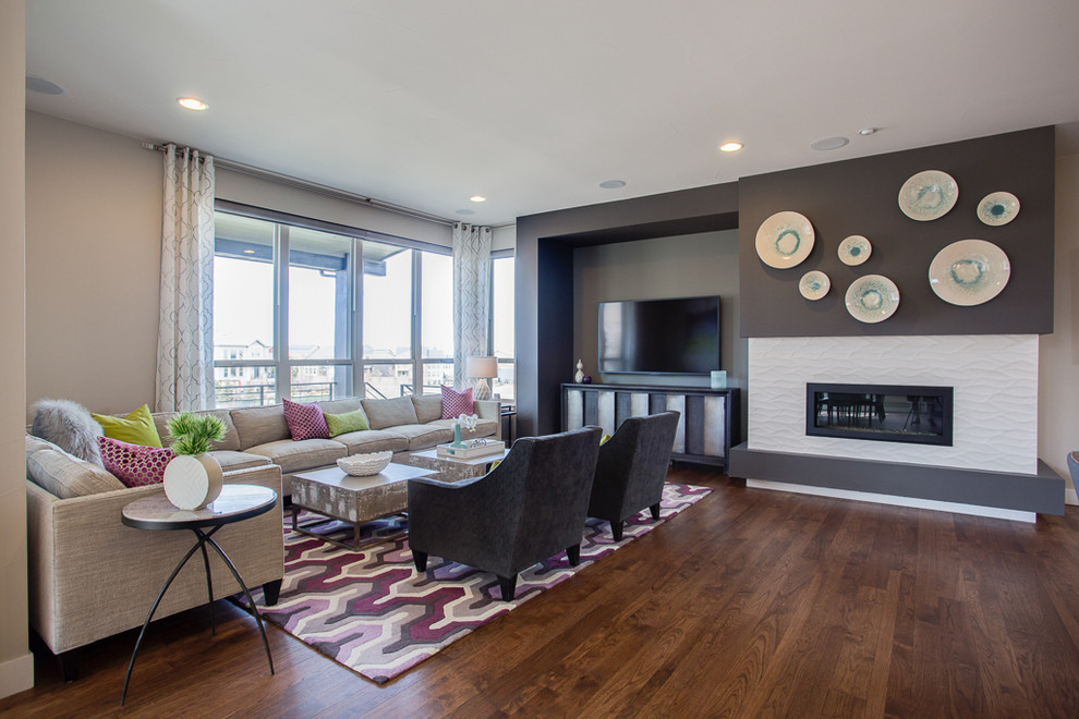 Example of a large minimalist open concept medium tone wood floor and brown floor family room design in Denver with gray walls, a ribbon fireplace, a tile fireplace and a wall-mounted tv