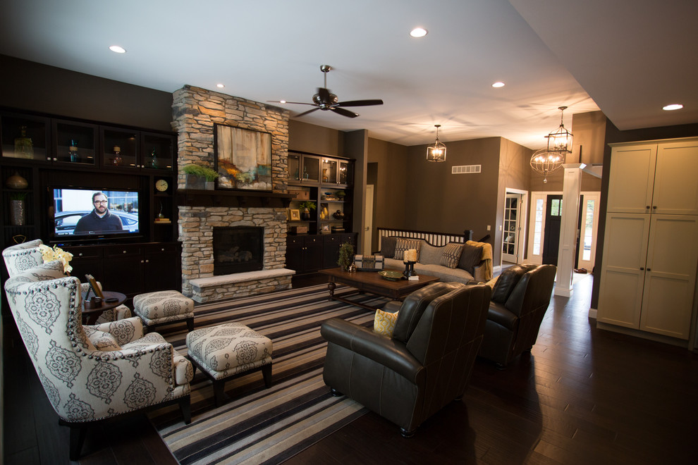 Classic open plan games room in Other with brown walls, dark hardwood flooring, a standard fireplace, a stone fireplace surround and a built-in media unit.
