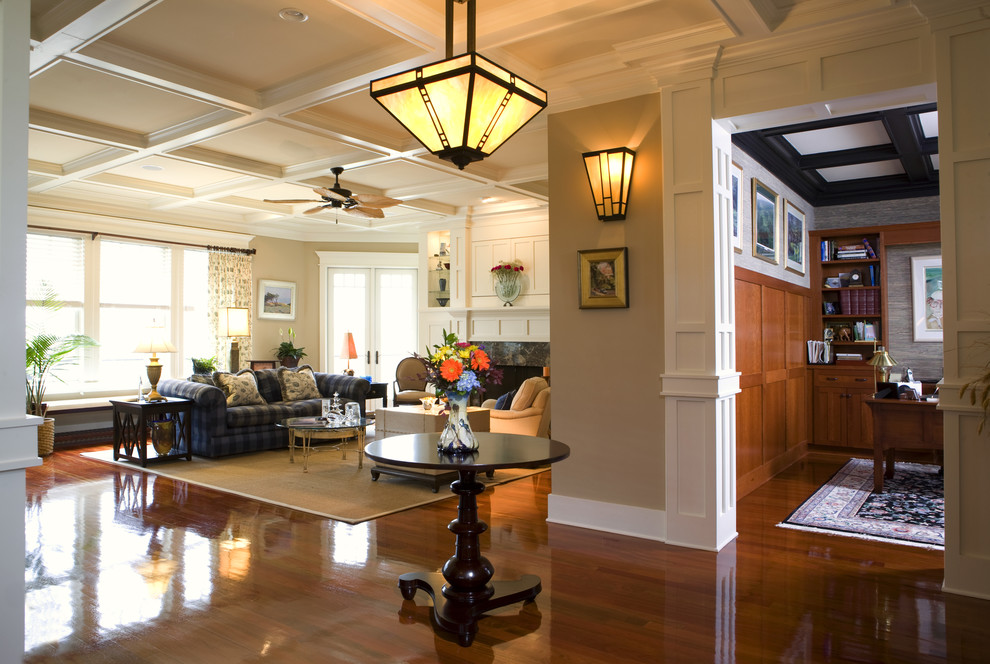 Inspiration for a craftsman open concept dark wood floor family room remodel in Charleston with beige walls