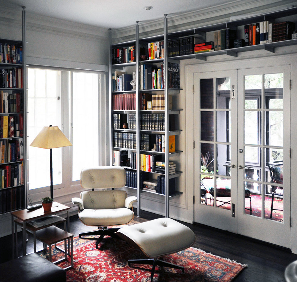 Inspiration for a mid-sized modern enclosed dark wood floor family room library remodel in Chicago with white walls